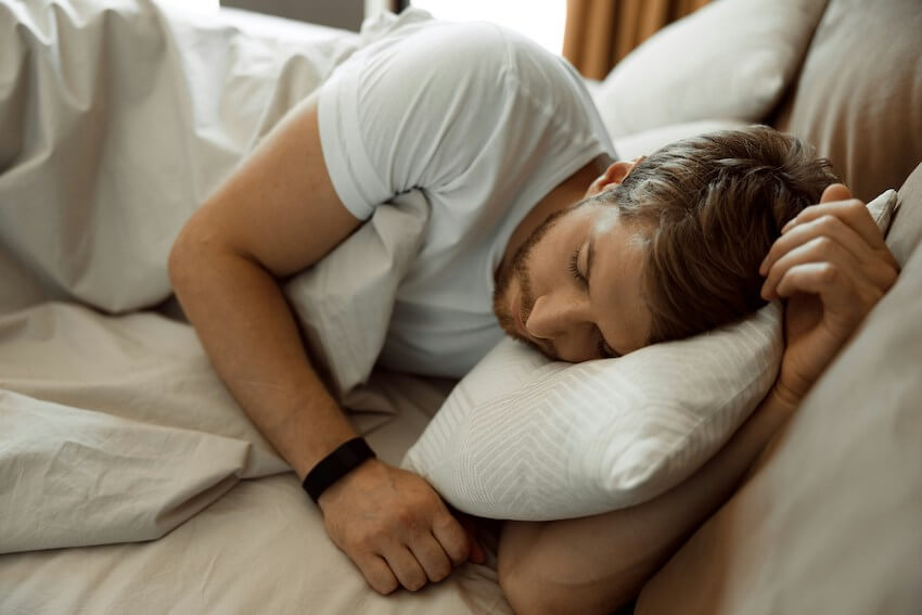man asleep in bed
