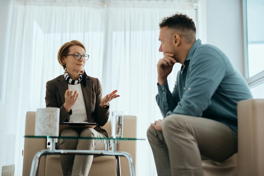 man speaking with a mental health professional