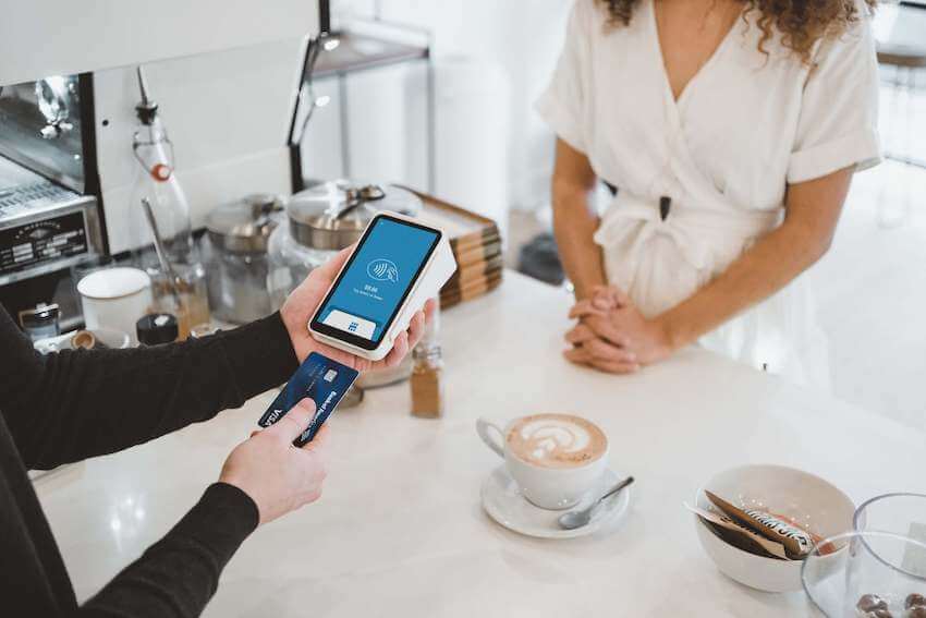 woman paying for a cup of coffee