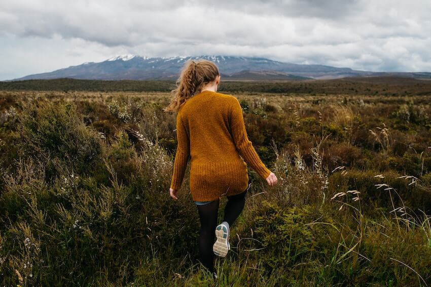 woman walking forward in an unmarked path