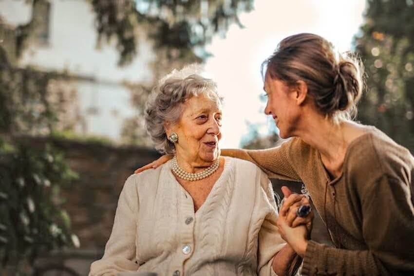 woman with her arm around an elderly woman