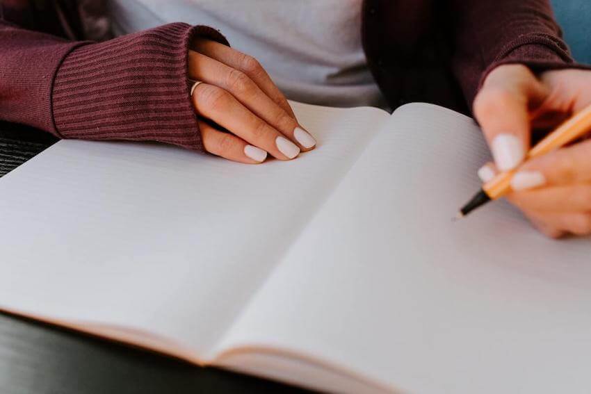 woman writing in a journal